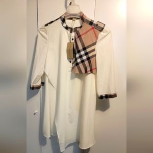 Women Top, new with tag. White blouse with a Burberry color accessory. Size XL